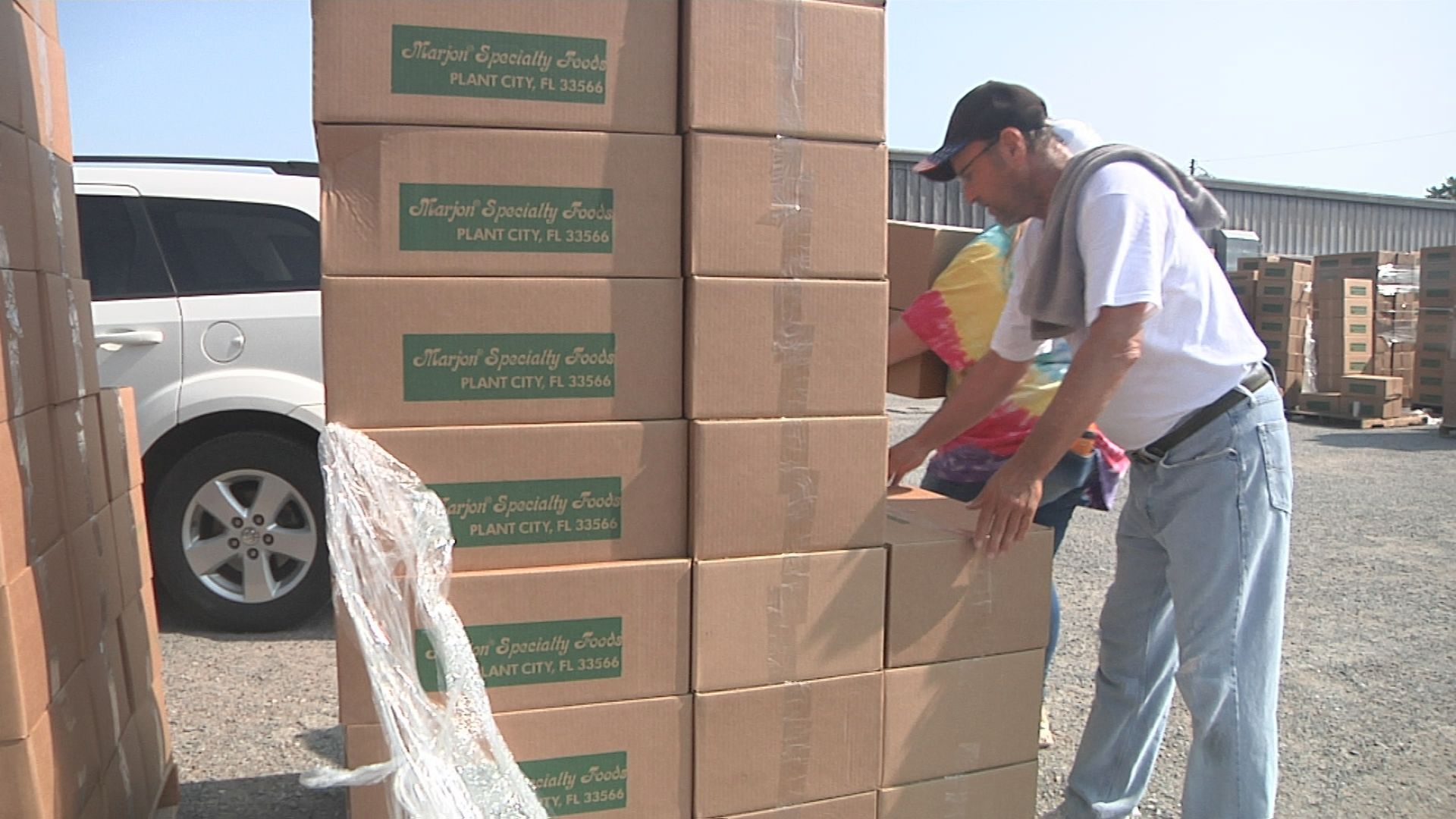 Doug Moore helps unload boxes of food
